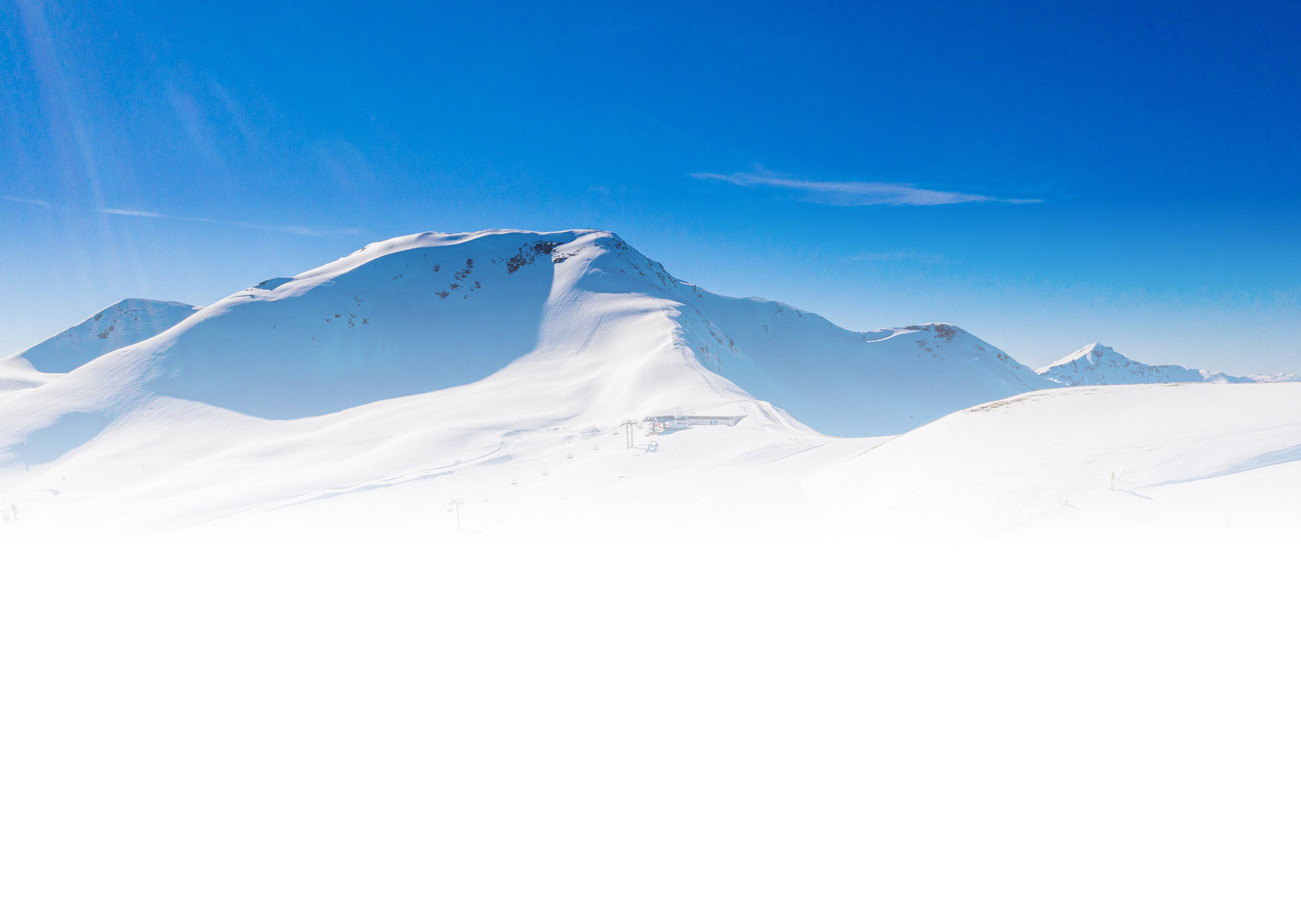 A ski resort surrounded by snow-covered mountains